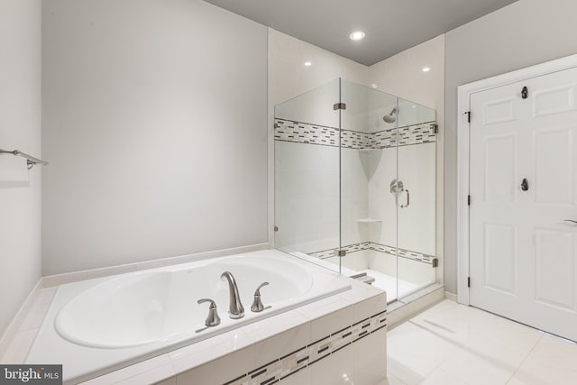 bathroom featuring tile patterned flooring and independent shower and bath