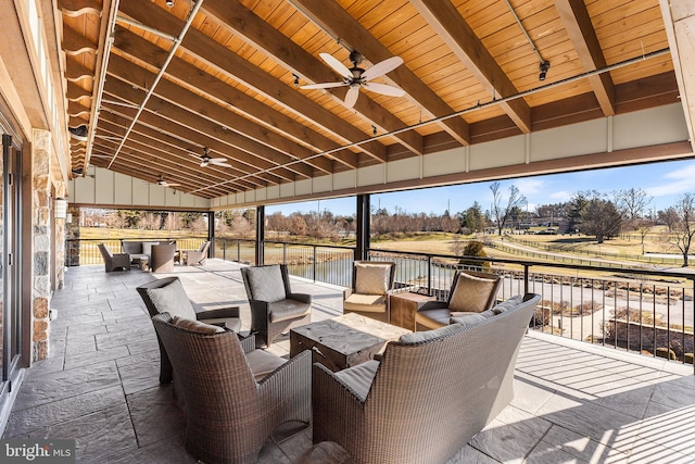 view of patio / terrace featuring outdoor lounge area, ceiling fan, a water view, and a rural view