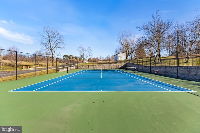 view of tennis court featuring basketball hoop