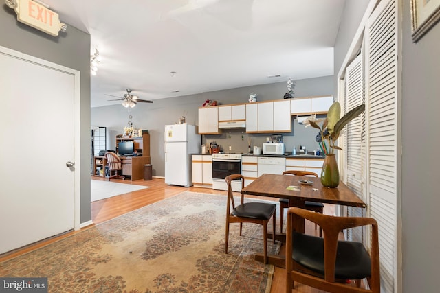 kitchen featuring ceiling fan, sink, white appliances, white cabinets, and light wood-type flooring