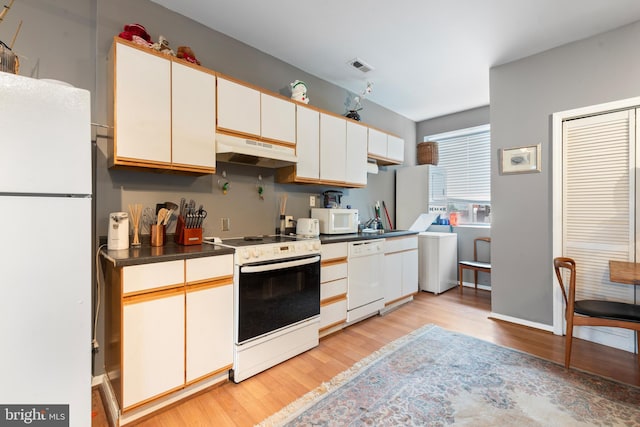 kitchen with white cabinetry, light hardwood / wood-style flooring, and white appliances