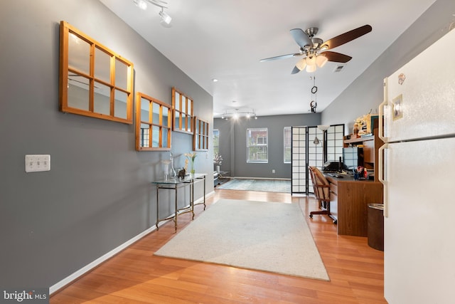 office space featuring light hardwood / wood-style flooring and ceiling fan