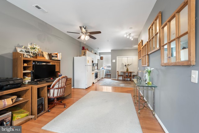 office space featuring ceiling fan and light hardwood / wood-style flooring