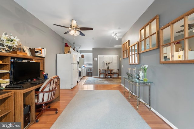 office featuring light wood-type flooring and ceiling fan