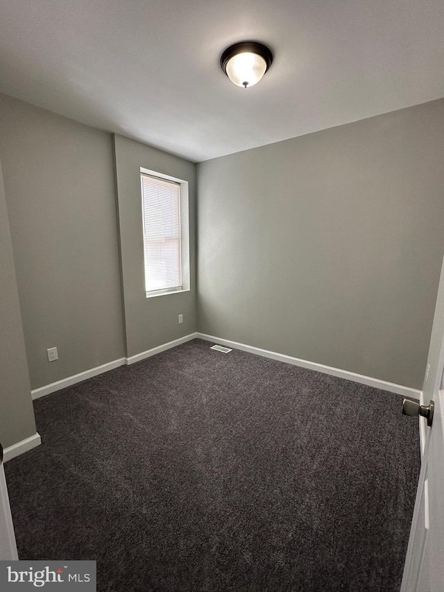 empty room with dark carpet