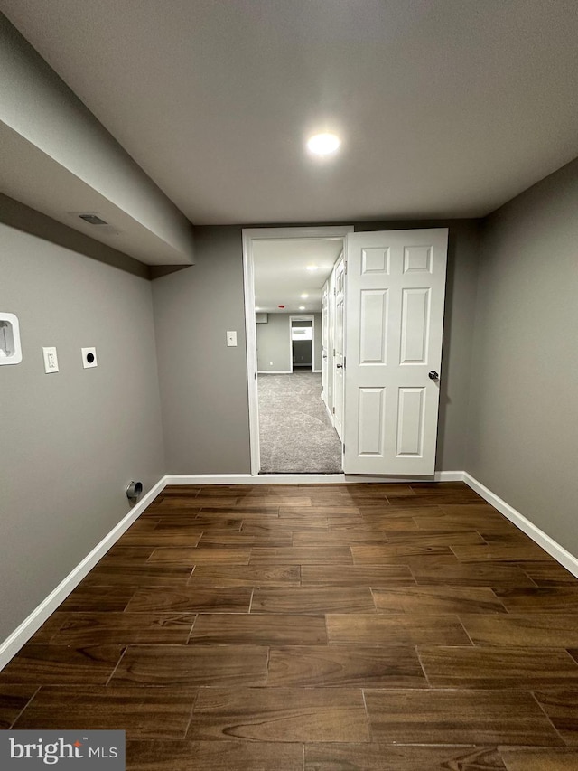 washroom with dark hardwood / wood-style flooring and hookup for an electric dryer