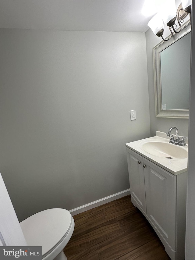 bathroom with vanity, hardwood / wood-style floors, and toilet