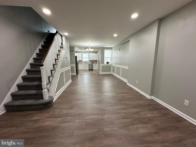 interior space with an inviting chandelier and dark hardwood / wood-style flooring