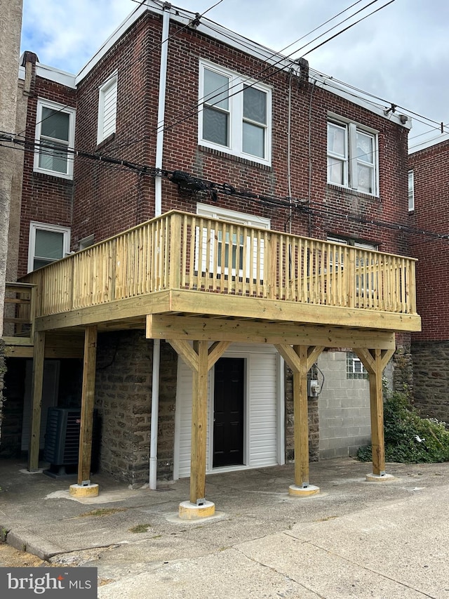 back of property featuring a deck and central AC unit