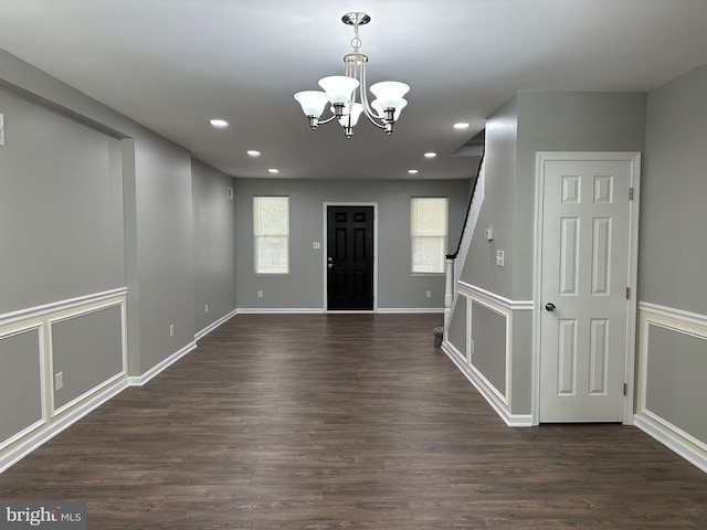 entryway with a chandelier and dark wood-type flooring