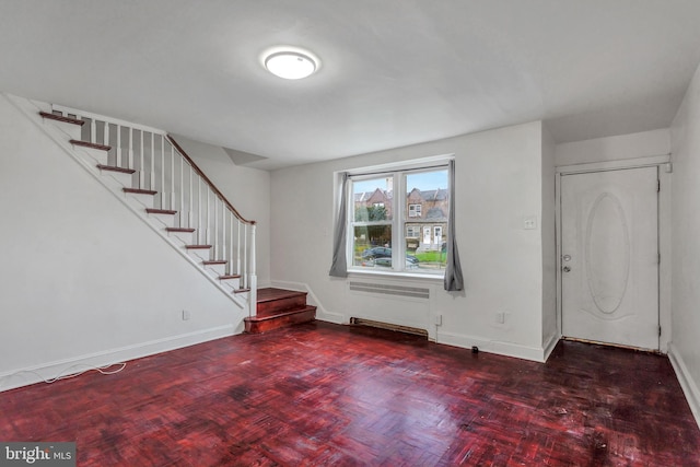 foyer entrance with dark parquet flooring