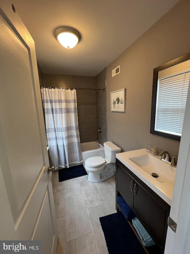 full bathroom with shower / bath combo, vanity, and toilet