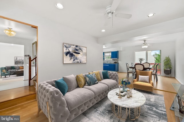 living room with wood-type flooring and ceiling fan