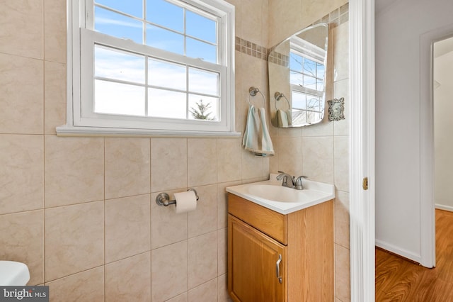 bathroom with vanity, toilet, plenty of natural light, and hardwood / wood-style floors