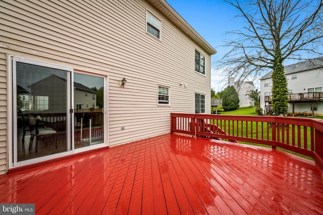 wooden deck featuring a yard