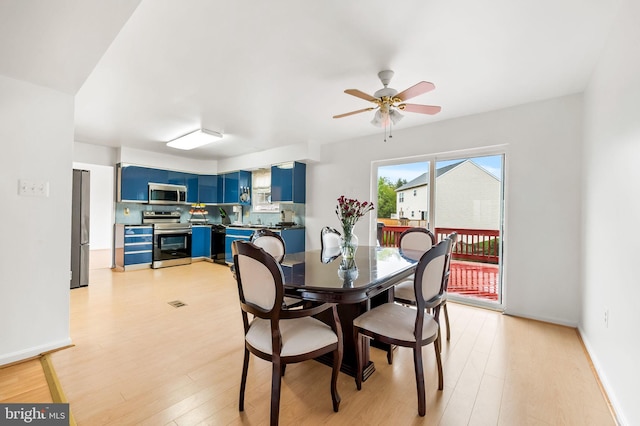 dining area featuring light wood-type flooring and ceiling fan