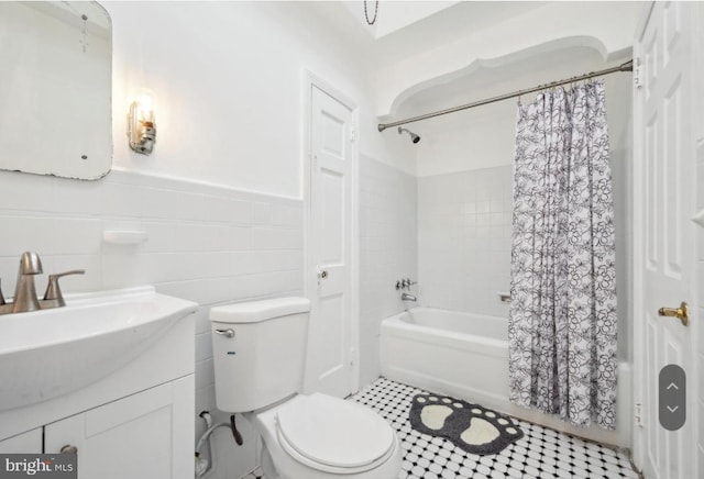 full bathroom featuring vanity, shower / tub combo, tile patterned floors, tile walls, and toilet