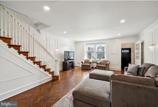 living room featuring ornamental molding and dark parquet flooring