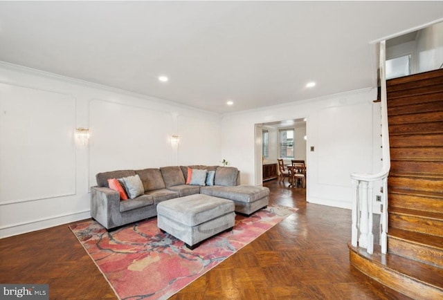 living room with dark parquet floors and ornamental molding