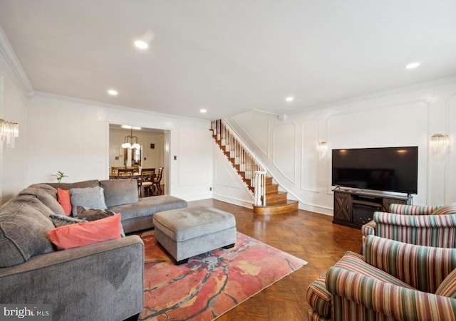 living room with crown molding, a chandelier, and dark parquet flooring