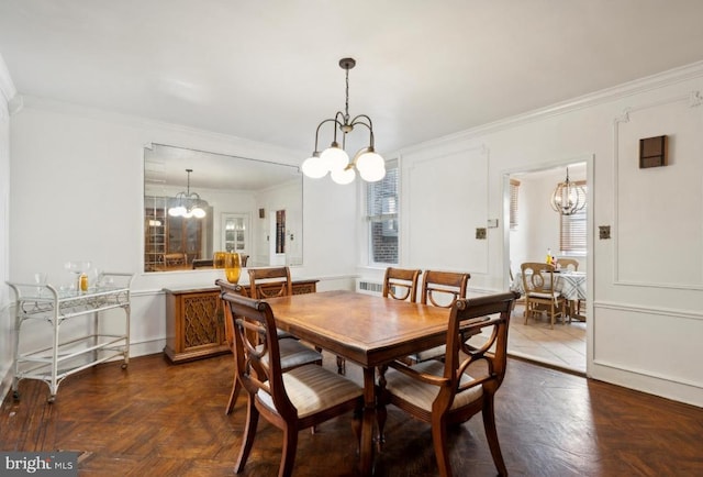 dining space with plenty of natural light, parquet floors, and crown molding