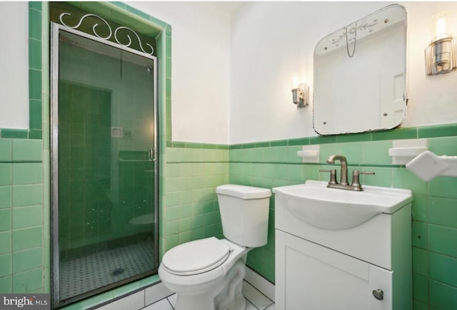 bathroom with tile walls, tile patterned flooring, an enclosed shower, vanity, and toilet