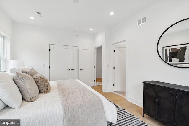 bedroom featuring light wood-type flooring and a closet