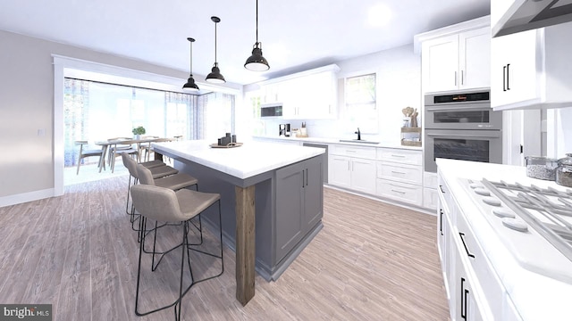 kitchen featuring appliances with stainless steel finishes, a wealth of natural light, light hardwood / wood-style floors, and white cabinets