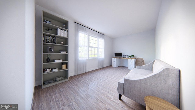 living area with vaulted ceiling and hardwood / wood-style floors