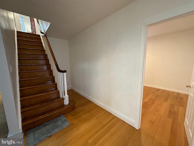 stairs featuring hardwood / wood-style floors