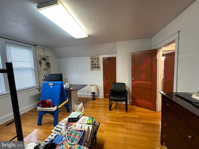 playroom featuring light hardwood / wood-style flooring and vaulted ceiling