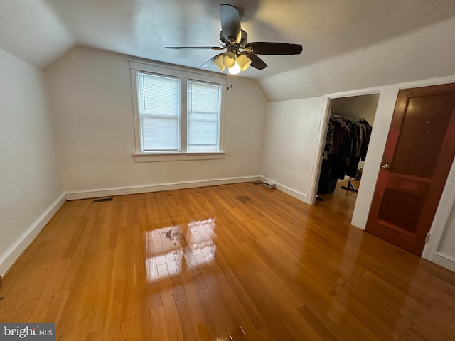 bonus room featuring vaulted ceiling, light hardwood / wood-style floors, and ceiling fan