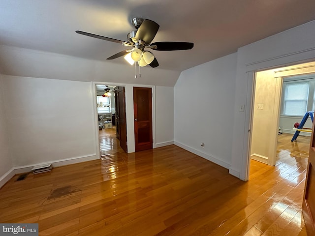 interior space with vaulted ceiling, light wood-type flooring, and ceiling fan