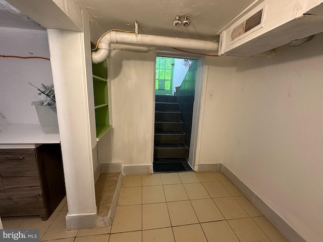 basement featuring light tile patterned floors