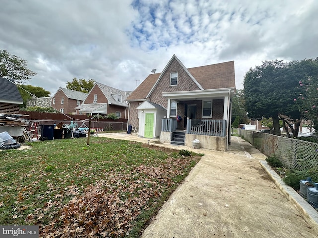 bungalow-style house with a front yard and a porch