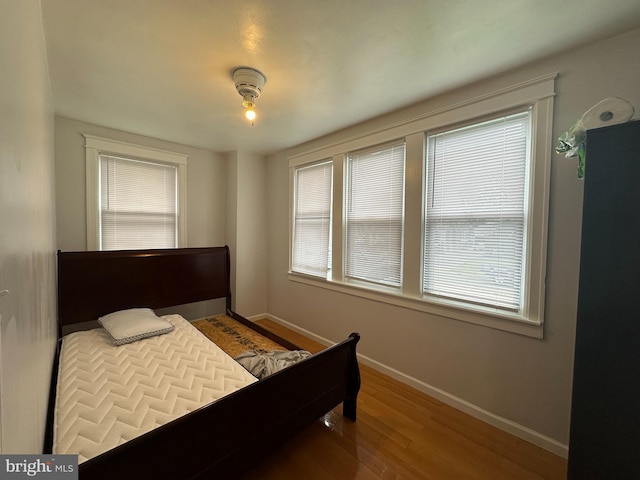 bedroom with hardwood / wood-style flooring