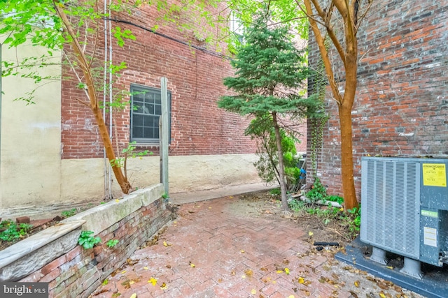 view of property exterior featuring a patio and central AC