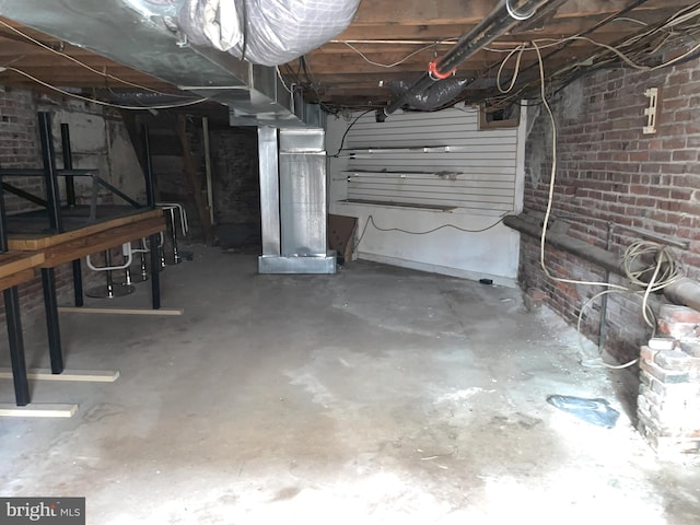 basement with brick wall