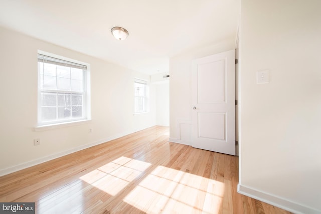 unfurnished room featuring light hardwood / wood-style flooring