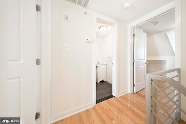 corridor with wood-type flooring