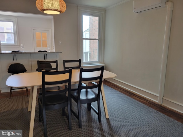 dining room featuring ornamental molding, an AC wall unit, dark hardwood / wood-style flooring, and plenty of natural light