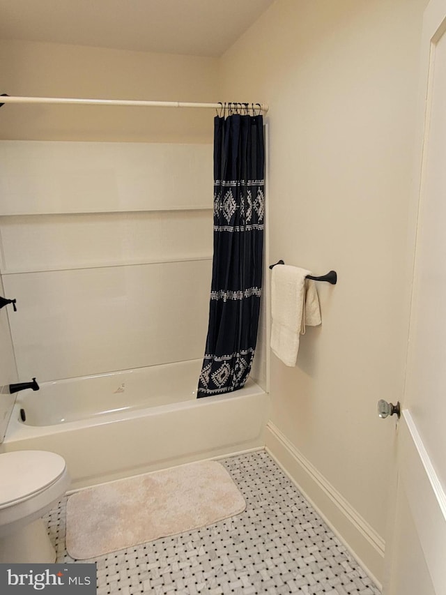 bathroom featuring toilet and shower / bathtub combination with curtain