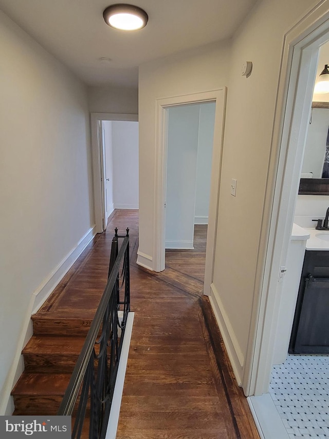 hallway featuring dark hardwood / wood-style floors and sink