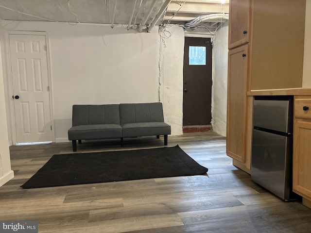 interior space featuring hardwood / wood-style floors and stainless steel refrigerator