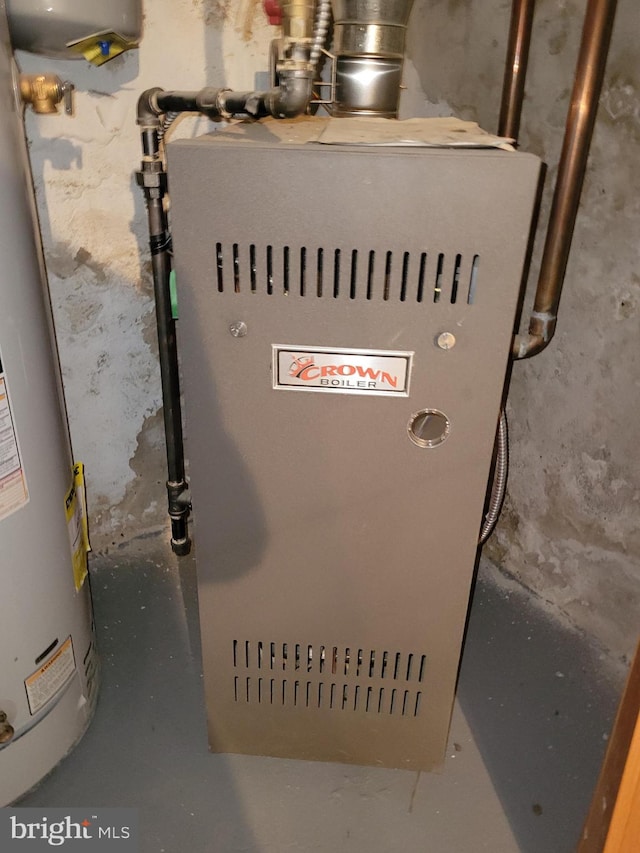 utility room featuring water heater