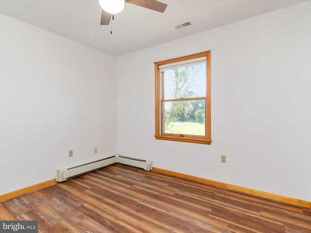 empty room featuring ceiling fan, dark wood-type flooring, and baseboard heating