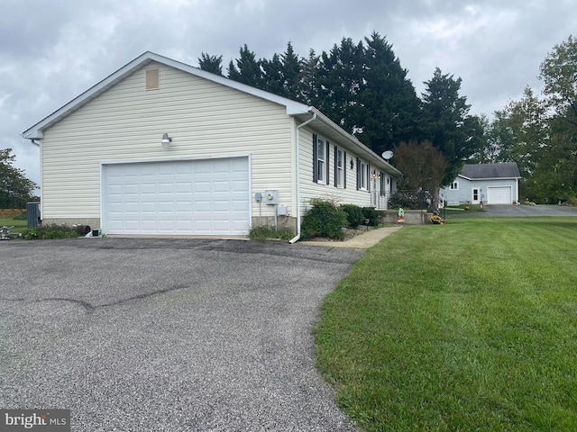 view of property exterior with a garage and a lawn