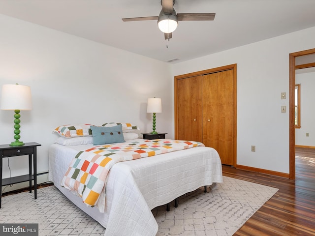 bedroom with ceiling fan, a closet, and hardwood / wood-style floors