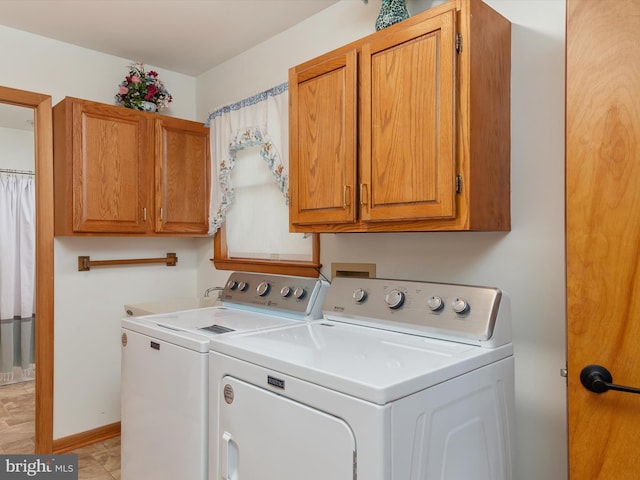 washroom featuring separate washer and dryer and cabinets