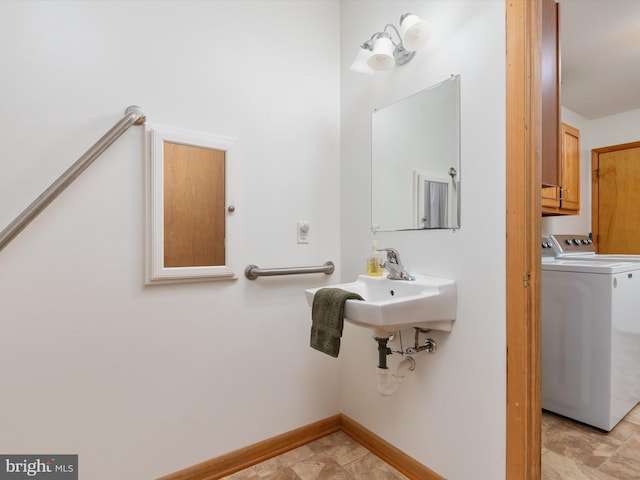 bathroom featuring washer and clothes dryer and sink